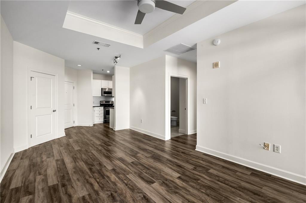 325 East Paces Ferry Road Northeast, Unit 1704 Atlanta, GA 30305 - Photo 24 of 43 a view of kitchen and empty room with wooden floor