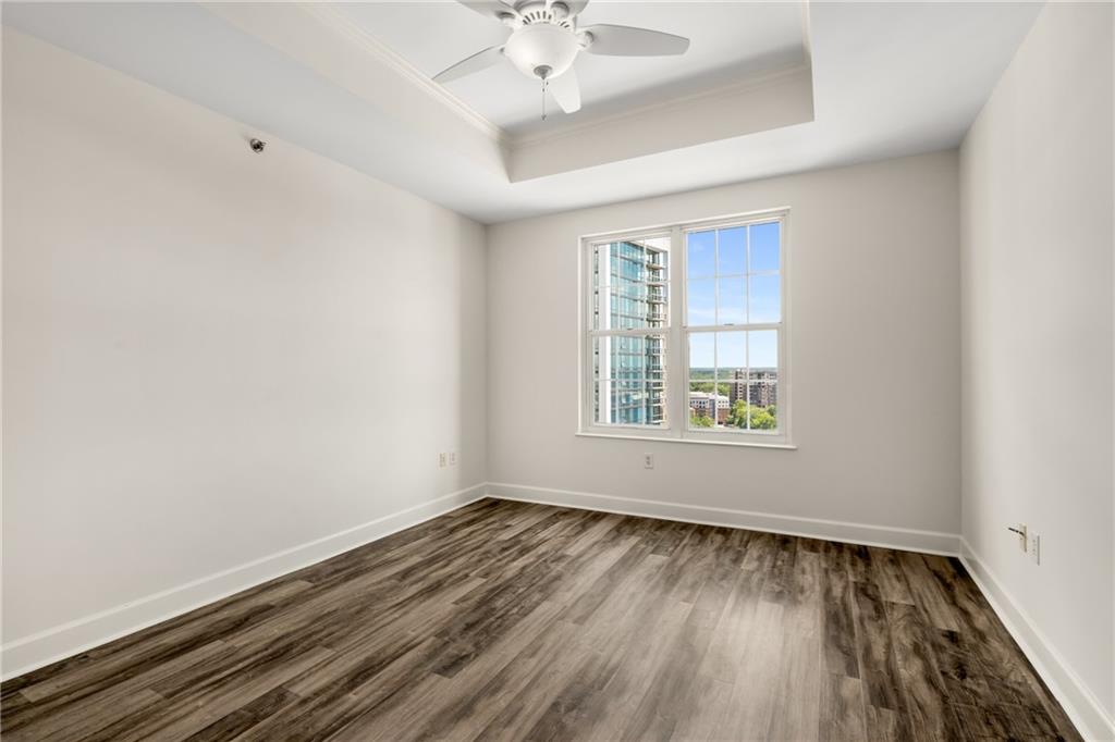325 East Paces Ferry Road Northeast, Unit 1704 Atlanta, GA 30305 - Photo 27 of 43 a view of an empty room with wooden floor and a window