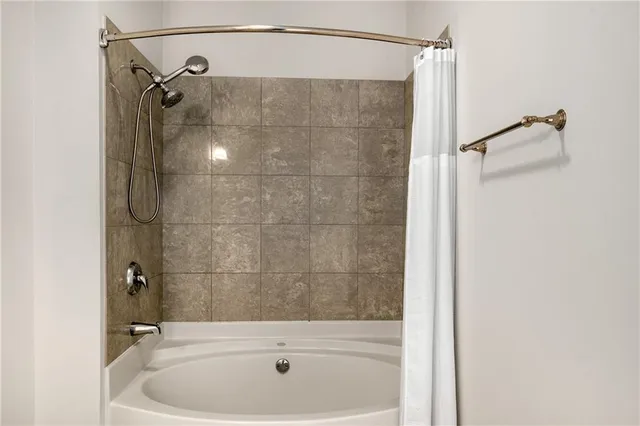 a bathroom with a shower and a sink