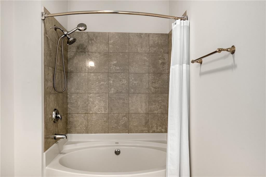 325 East Paces Ferry Road Northeast, Unit 1704 Atlanta, GA 30305 - Photo 31 of 43 a bathroom with a shower and a sink