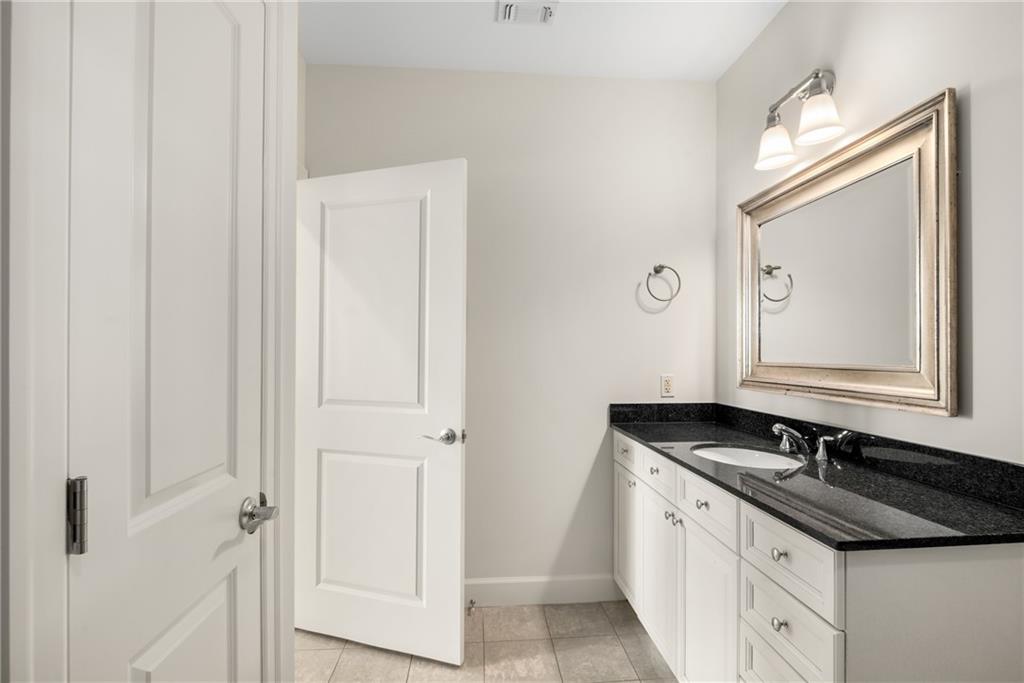 325 East Paces Ferry Road Northeast, Unit 1704 Atlanta, GA 30305 - Photo 32 of 43 a bathroom with a double vanity sink and mirror