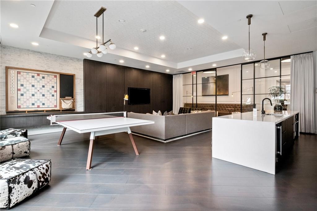 325 East Paces Ferry Road Northeast, Unit 1704 Atlanta, GA 30305 - Photo 37 of 43 a living room with furniture a rug and a chandelier