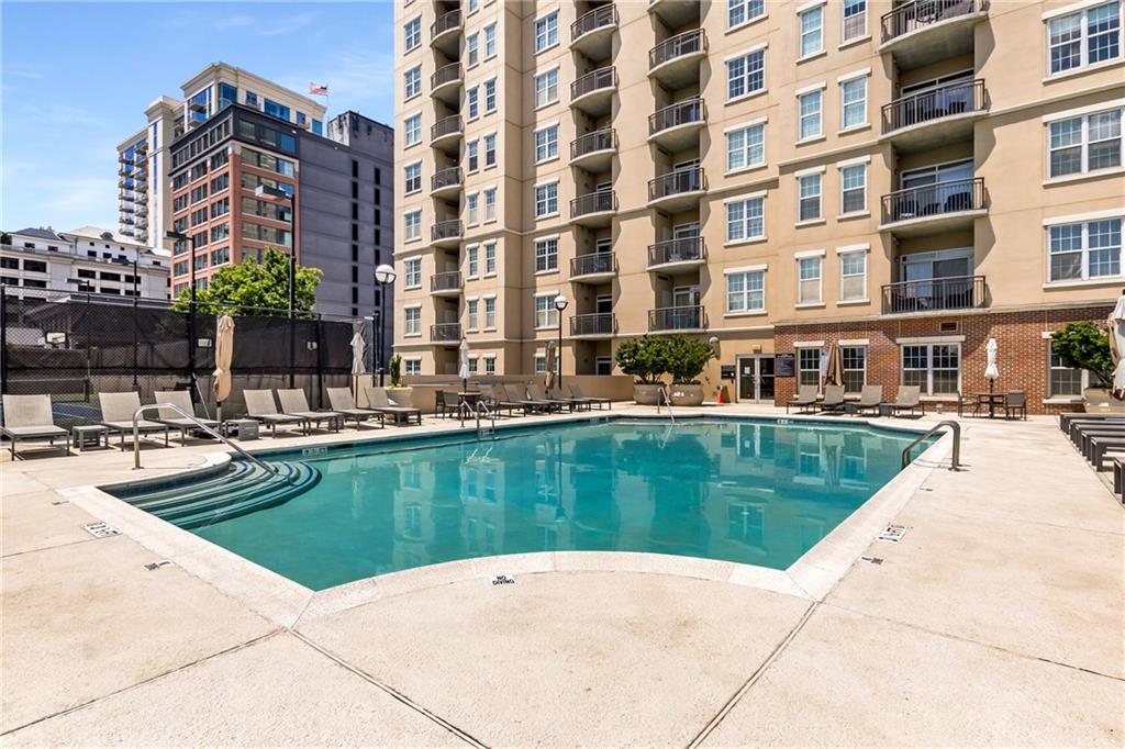 325 East Paces Ferry Road Northeast, Unit 1704 Atlanta, GA 30305 - Photo 41 of 43 a swimming pool with outdoor seating and yard