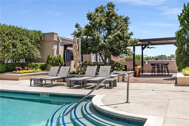 a swimming pool with outdoor seating and yard