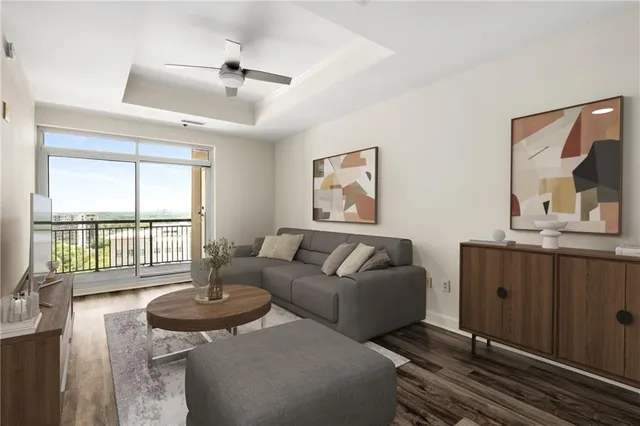 a living room with furniture and a floor to ceiling window