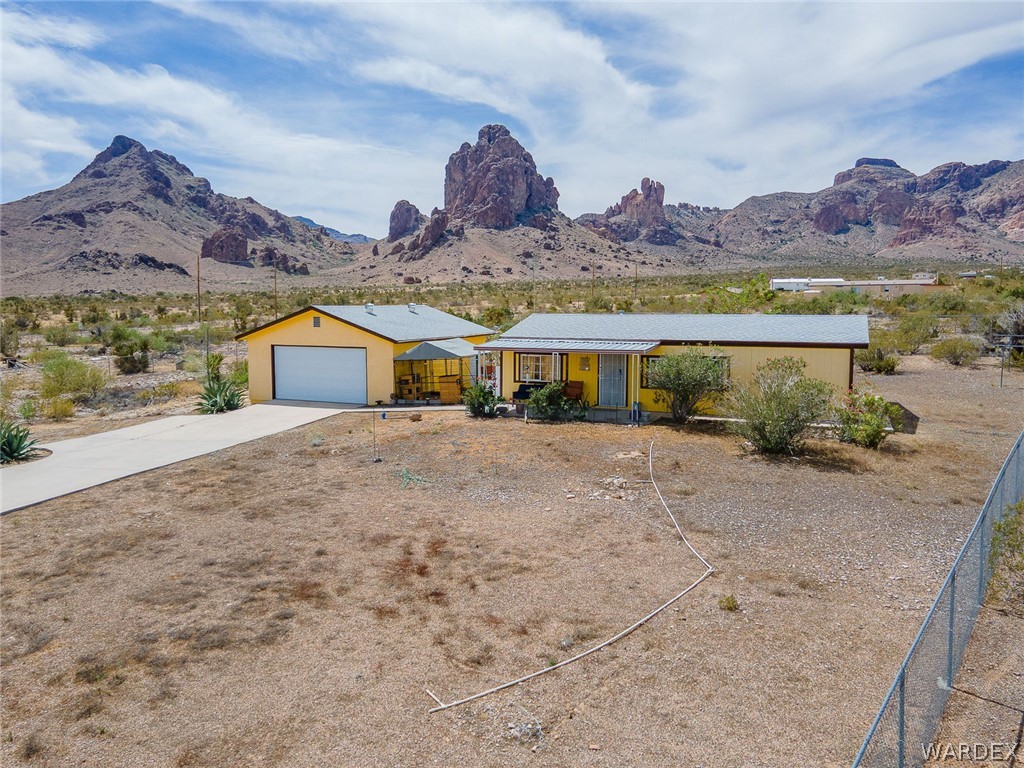 2465 Egar Road Golden Valley, AZ 86413 - Photo 73 of 98 This property features a single-story yellow residence with a gray roof and an attached garage