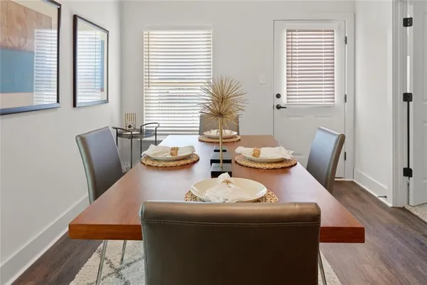 a dining room with furniture and wooden floor
