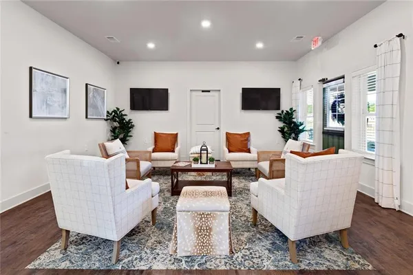 a living room with couches and a flat screen tv