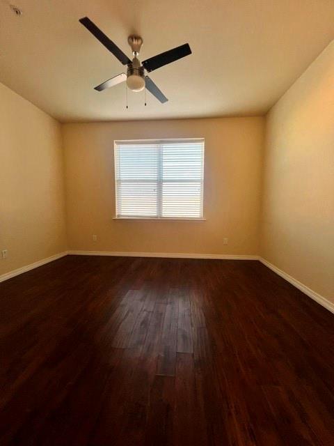 1100 West Trinity Mills Road, Unit 2001 Carrollton, TX 75006 - Photo 18 of 23 a view of an empty room with wooden floor and a window