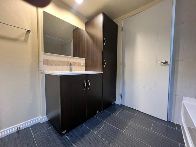1100 West Trinity Mills Road, Unit 2001 Carrollton, TX 75006 - Photo 19 of 23 a bathroom with a sink and a mirror