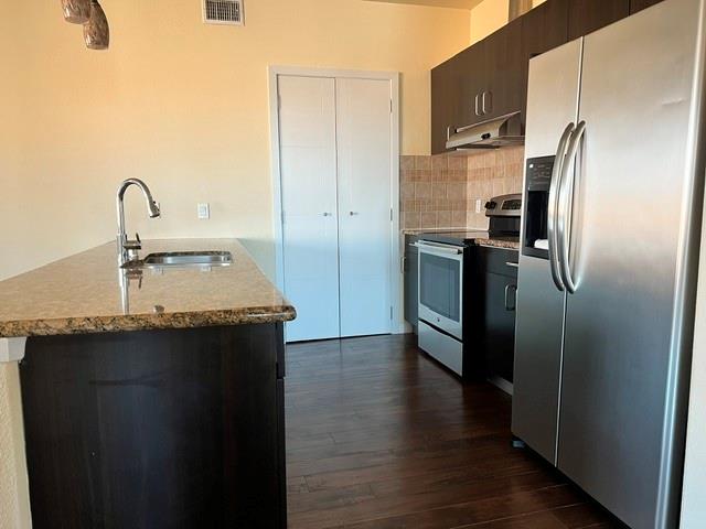 1100 West Trinity Mills Road, Unit 2001 Carrollton, TX 75006 - Photo 8 of 23 a kitchen with stainless steel appliances a sink stove and refrigerator