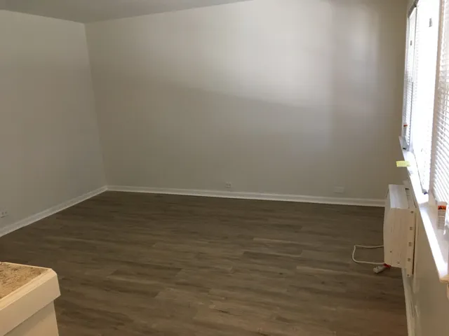 a view of wooden floor and brick walls