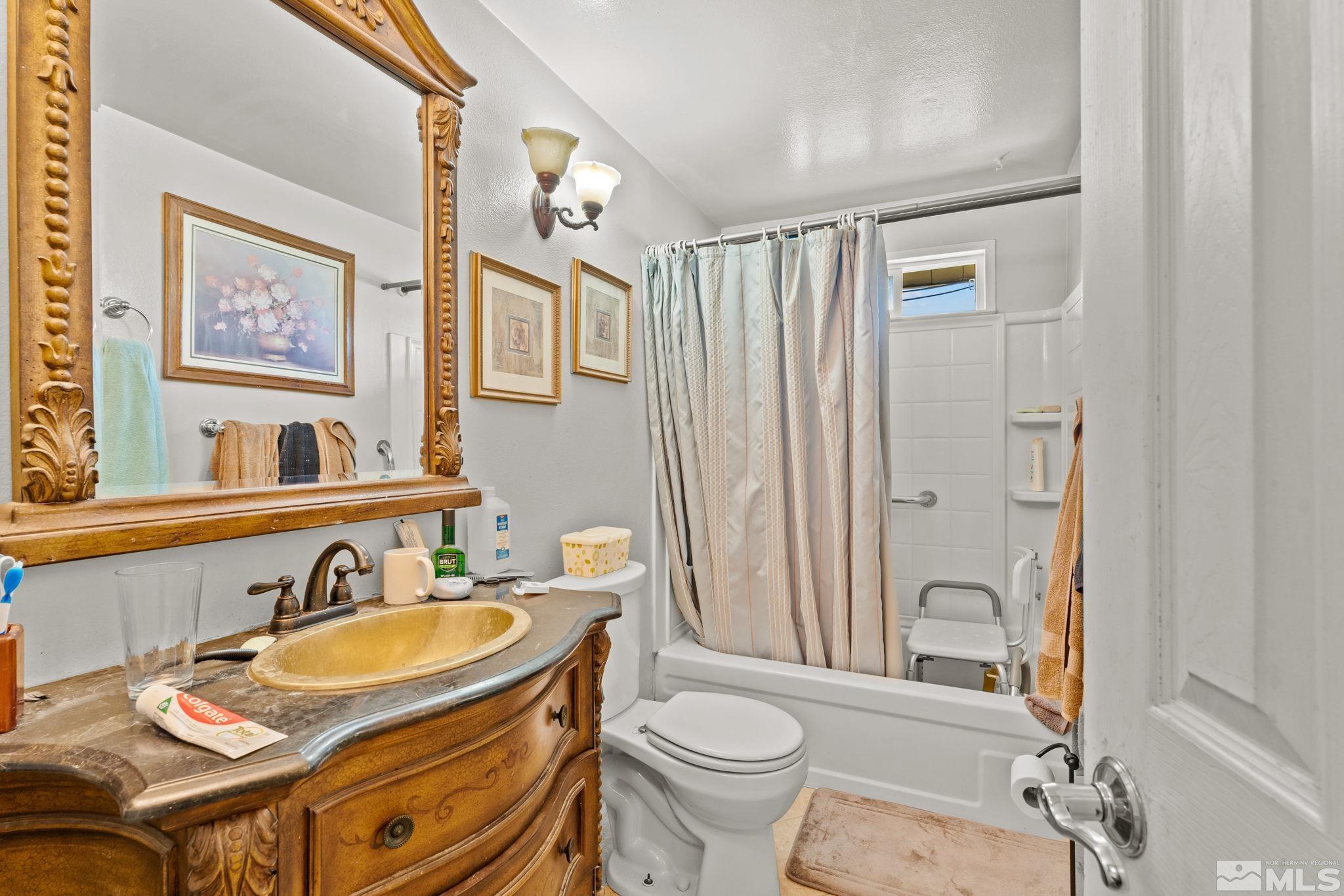 9295 Fremont Way Reno, NV 89506 - Photo 21 of 37 a bathroom with a granite countertop sink toilet and shower