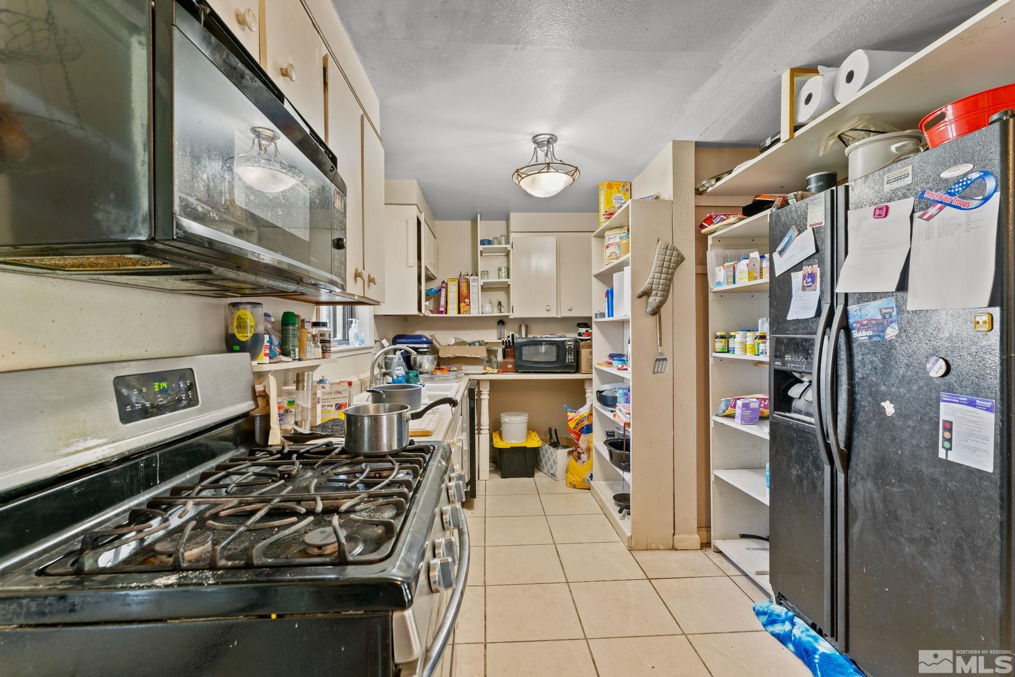 9295 Fremont Way Reno, NV 89506 - Photo 8 of 37 a kitchen with stainless steel appliances granite countertop a refrigerator and a stove