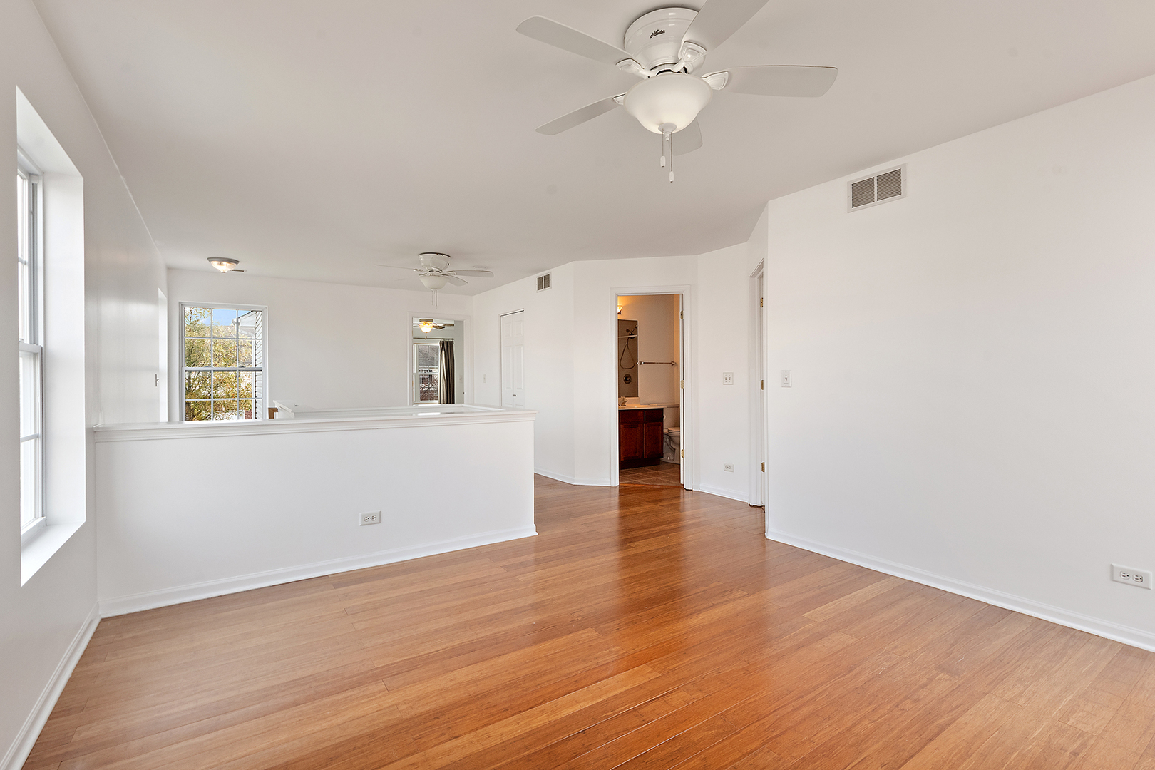 1977 Crestview Circle, Unit 1973 Romeoville, IL 60446 - Photo 14 of 19 an empty room with wooden floor and windows