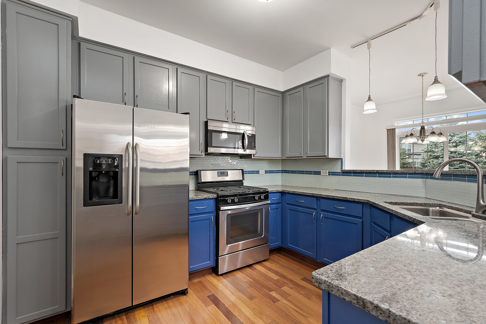 1977 Crestview Circle, Unit 1973 Romeoville, IL 60446 - Photo 6 of 19 a kitchen with kitchen island granite countertop wooden cabinets stainless steel appliances and a counter space