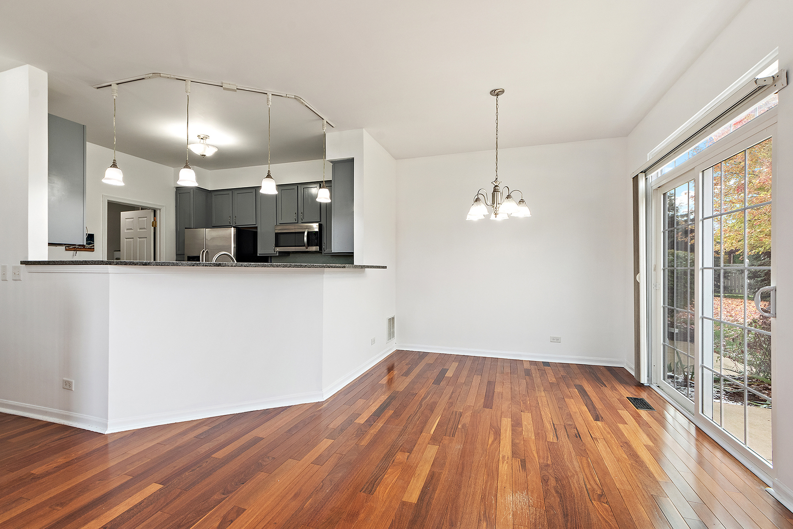1977 Crestview Circle, Unit 1973 Romeoville, IL 60446 - Photo 8 of 19 a view of a kitchen with wooden floor and windows