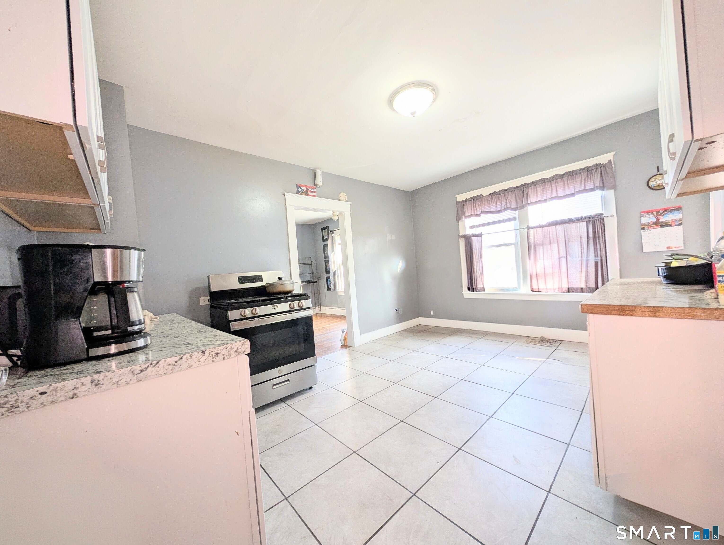 905 Cooke Street Waterbury, CT 06704 - Photo 13 of 42 a kitchen with a stove a sink dishwasher and a refrigerator