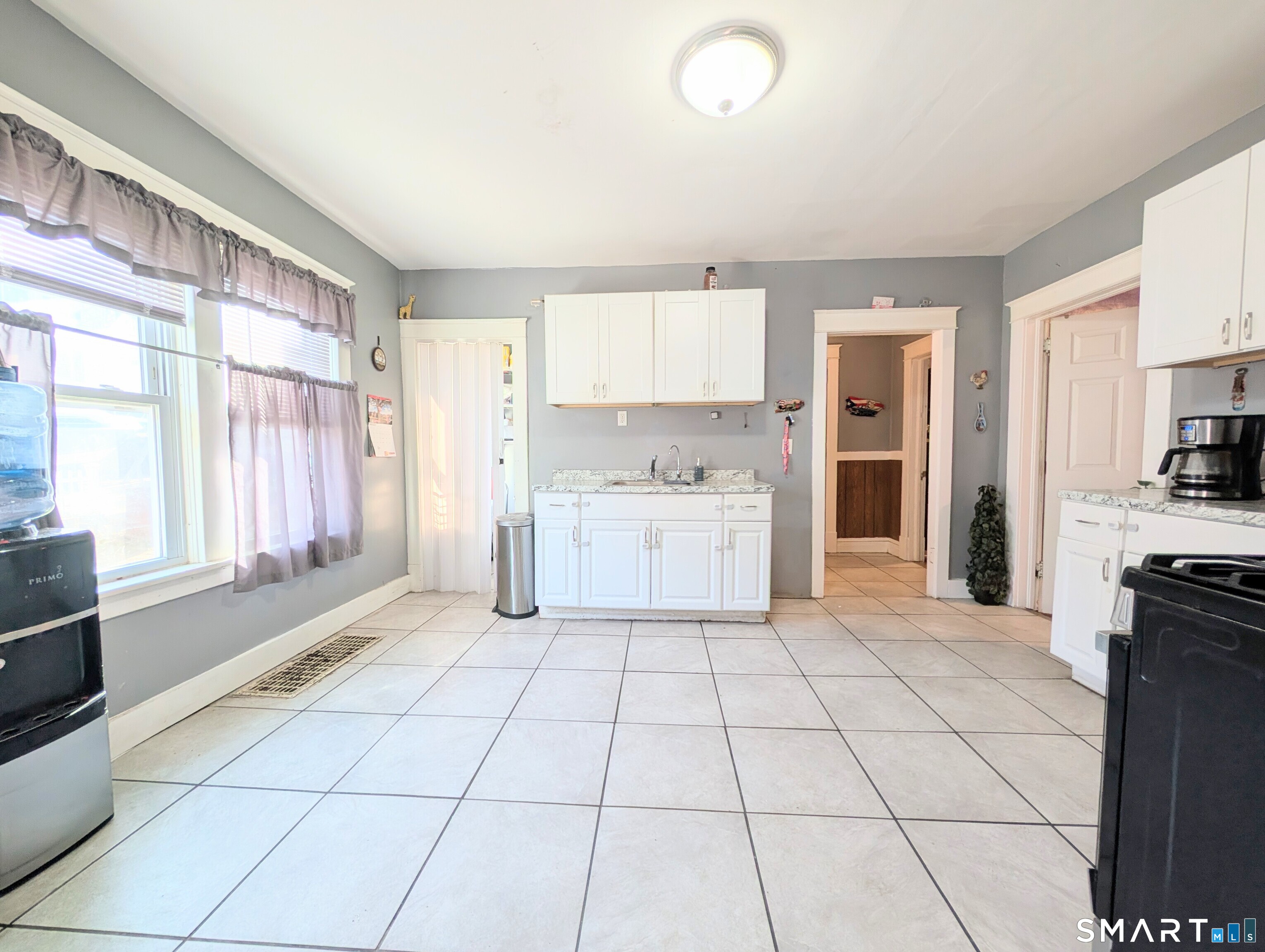 905 Cooke Street Waterbury, CT 06704 - Photo 14 of 42 a kitchen with a stove a sink and a refrigerator