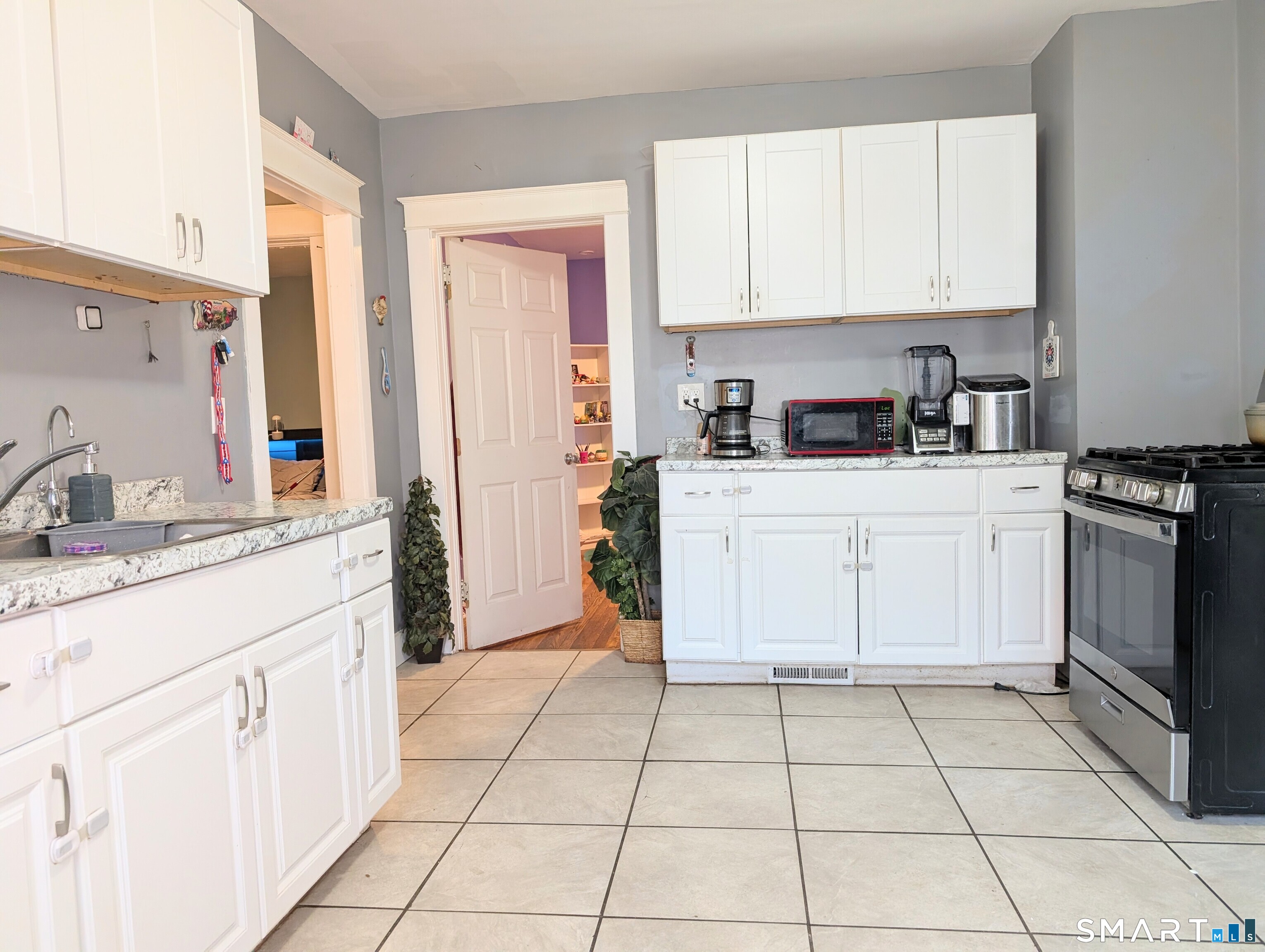 905 Cooke Street Waterbury, CT 06704 - Photo 16 of 42 a kitchen with a stove sink and cabinets