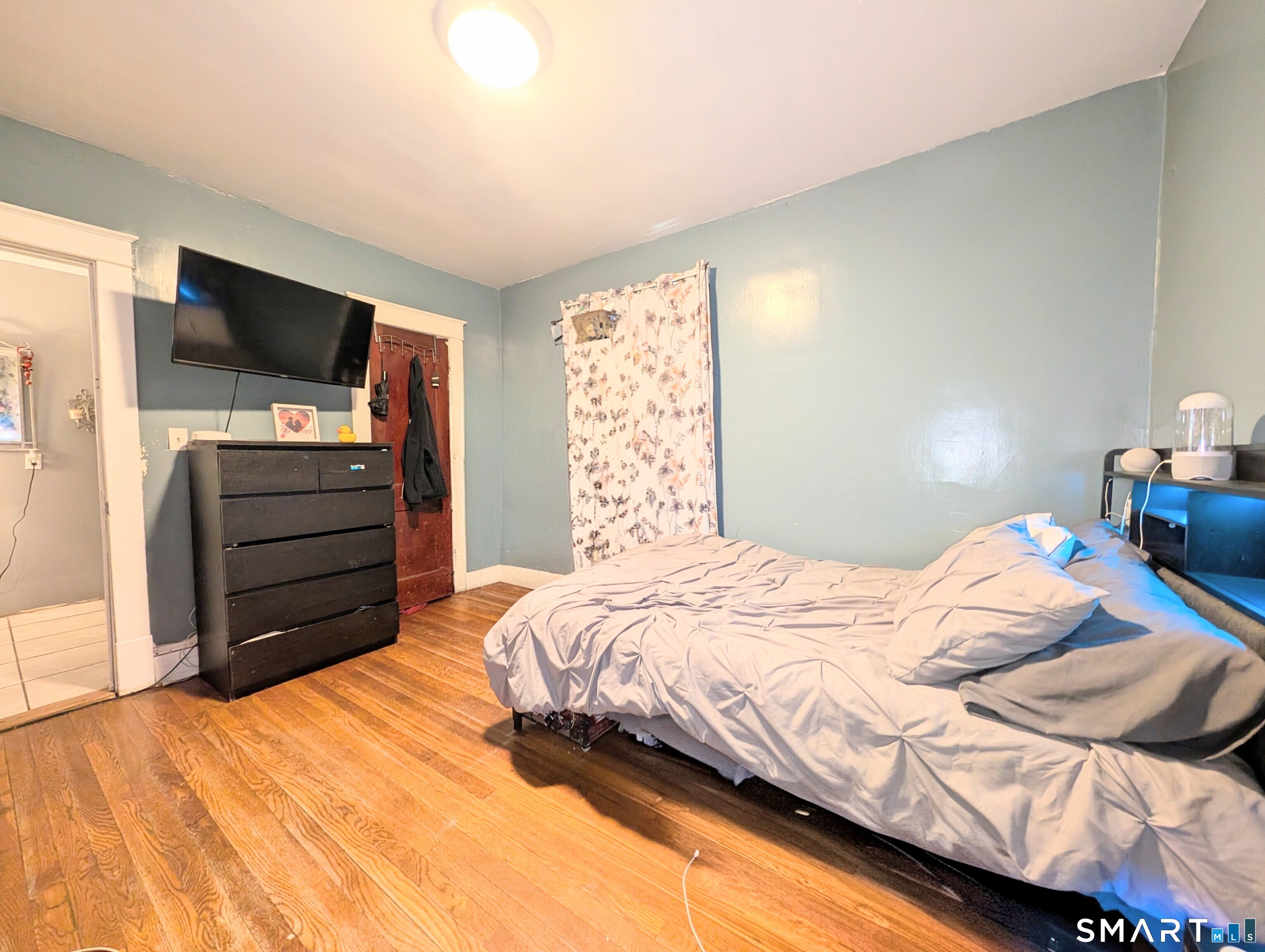 905 Cooke Street Waterbury, CT 06704 - Photo 22 of 42 a bedroom with a bed and flat screen tv