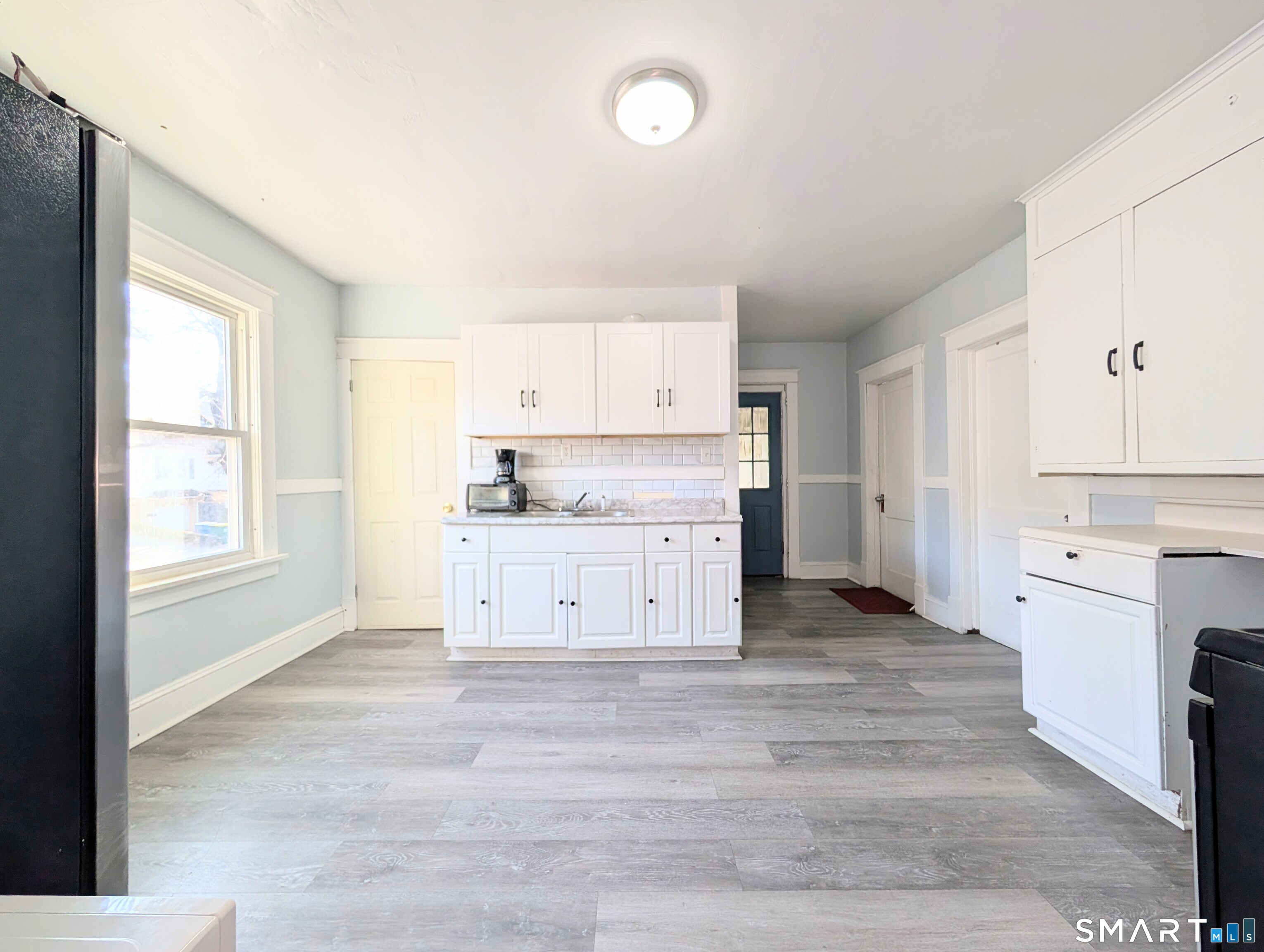 905 Cooke Street Waterbury, CT 06704 - Photo 25 of 42 a kitchen with granite countertop white cabinets and white appliances