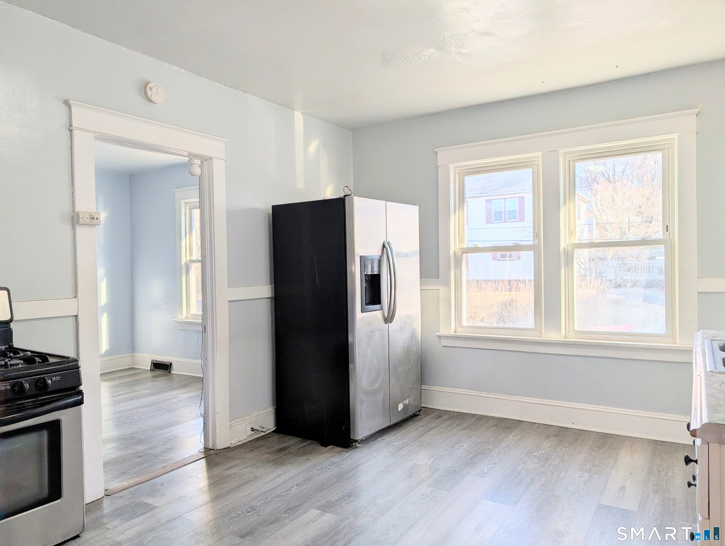 905 Cooke Street Waterbury, CT 06704 - Photo 27 of 42 an empty room with wooden floor and a window