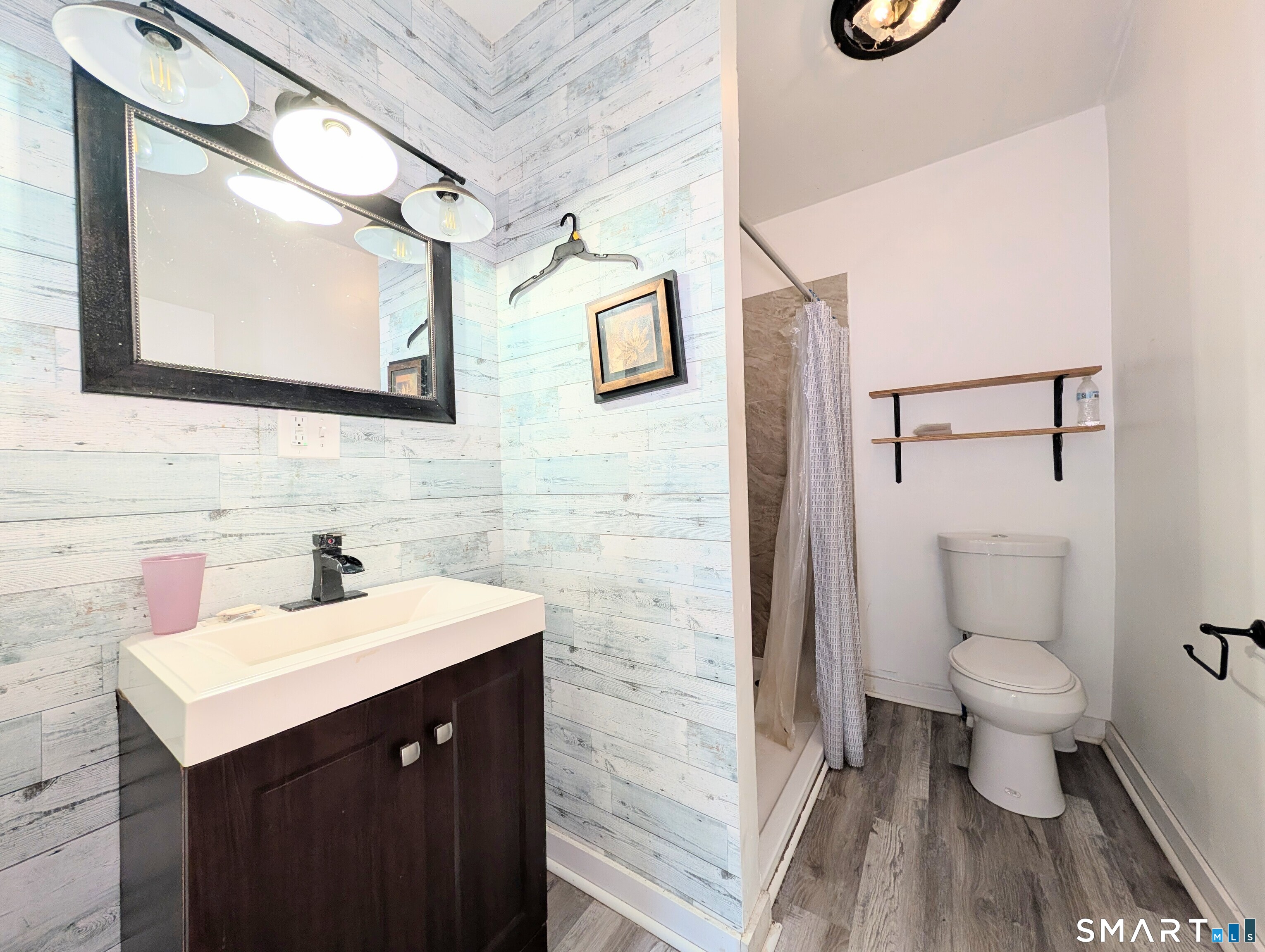 905 Cooke Street Waterbury, CT 06704 - Photo 32 of 42 a bathroom with a sink mirror vanity and toilet