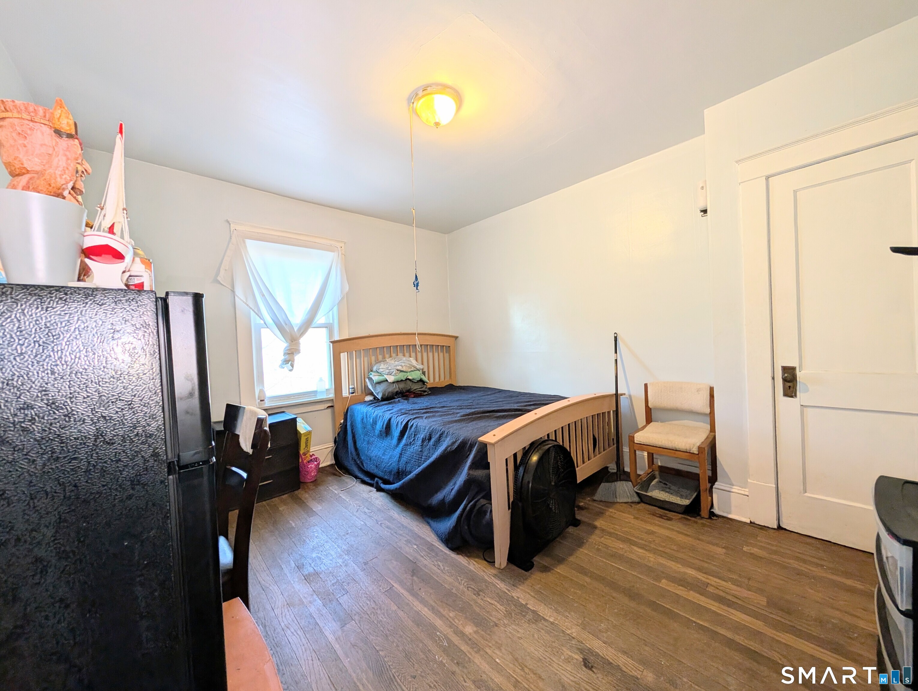 905 Cooke Street Waterbury, CT 06704 - Photo 34 of 42 a bed room with a bed and a lamp