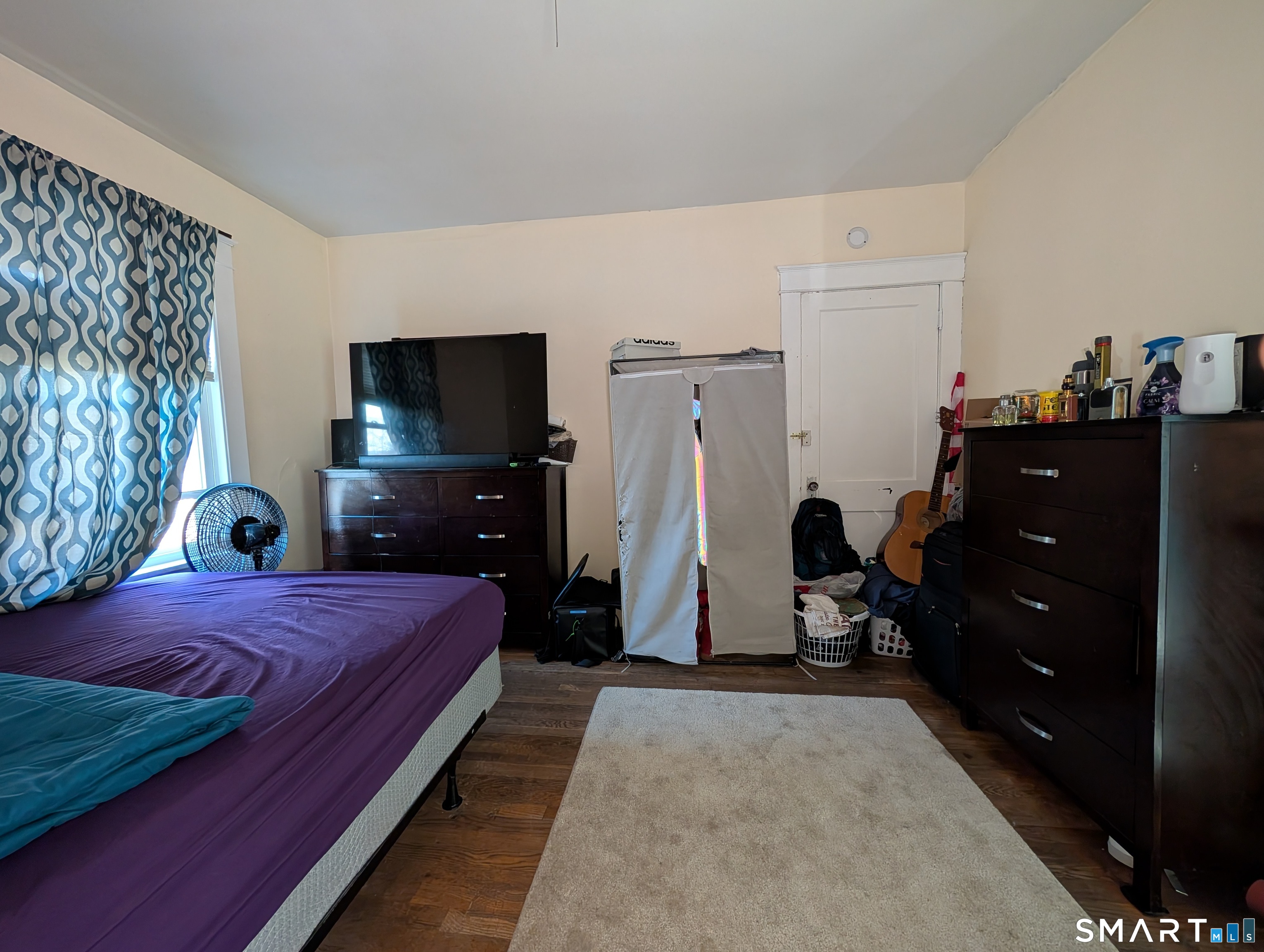 905 Cooke Street Waterbury, CT 06704 - Photo 35 of 42 a bedroom with a bed and a flat tv screen on dresser