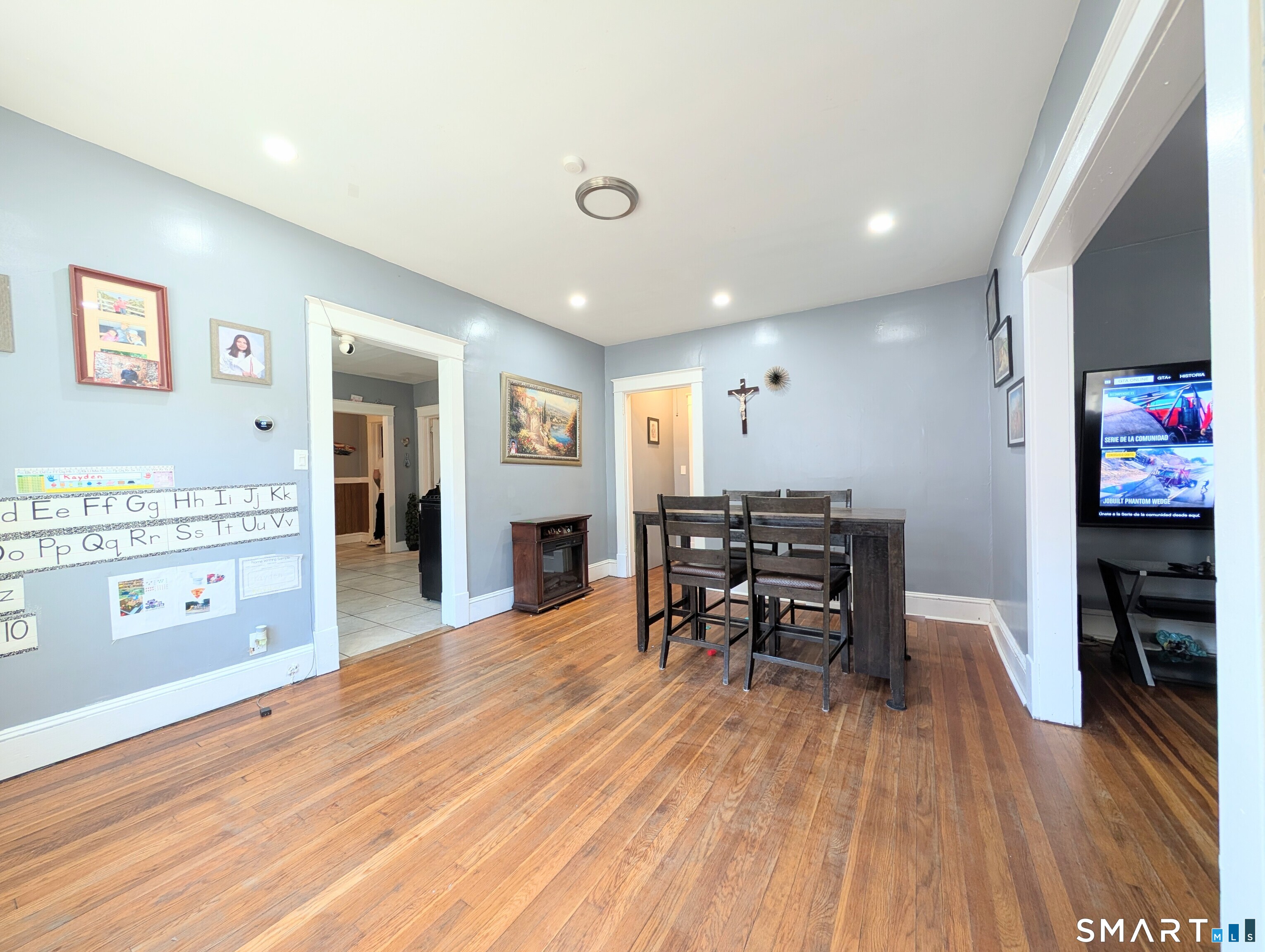 905 Cooke Street Waterbury, CT 06704 - Photo 10 of 42 a open kitchen with stainless steel appliances dining table chairs and wooden floor