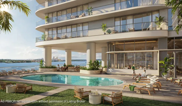 a view of a building with a swimming pool and a chairs