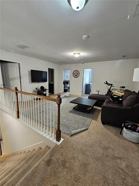 5747 Radford Loop Fairburn, GA 30213 - Photo 12 of 36 a living room with furniture and a flat screen tv