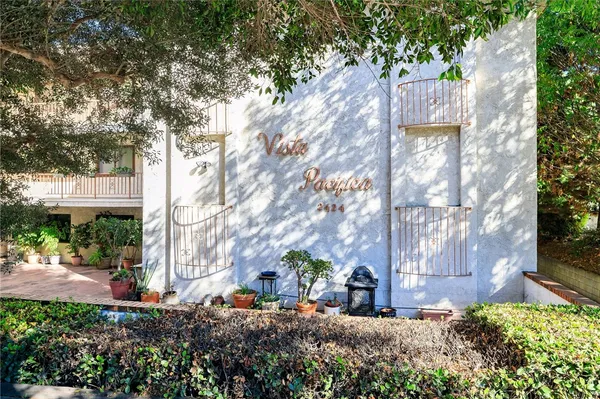 a view of a street with large trees
