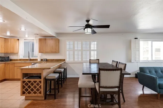 a view of a a dining room with furniture window and wooden floor