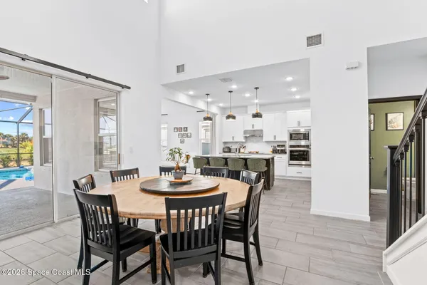 a dining room with furniture and wooden floor