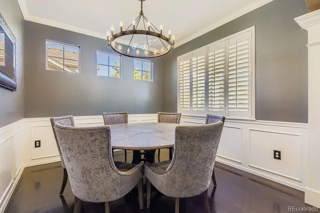 a dining room with furniture a chandelier and window