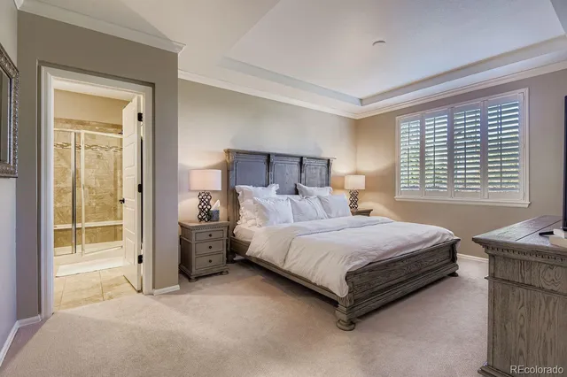 a spacious bedroom with a bed and a large window