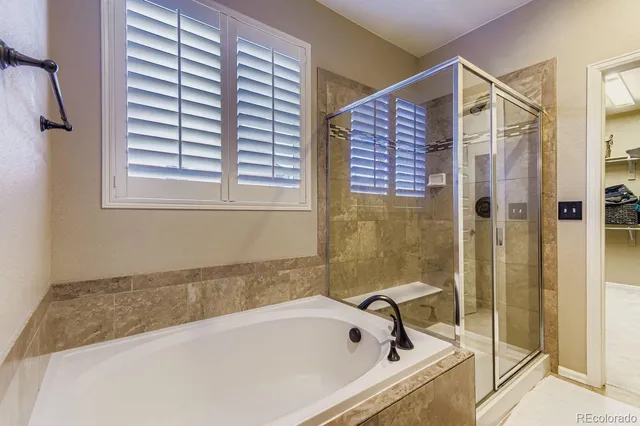 a bathroom with a bathtub and shower