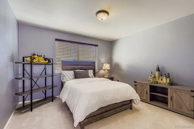 a bedroom with a bed and dresser