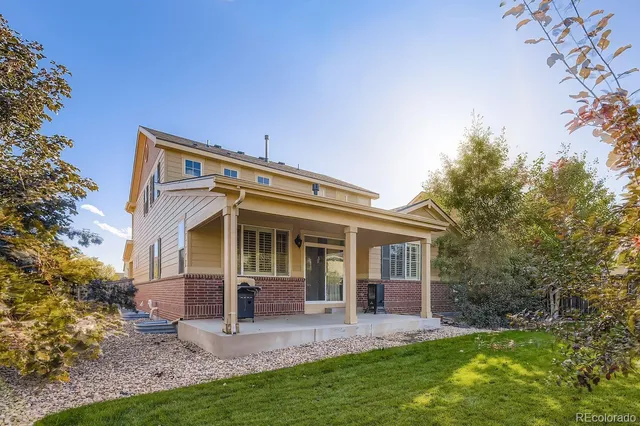 a view of a house with a yard and porch