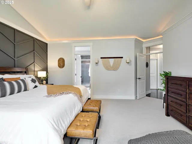 a bedroom with bed and wooden floor