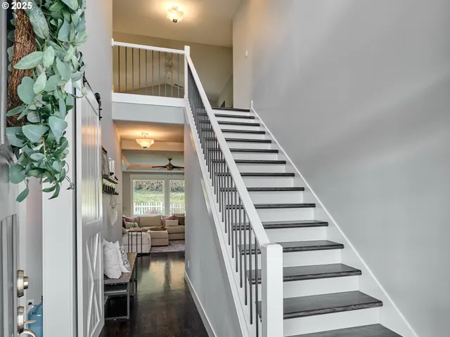 a view of entryway and hall with wooden floor