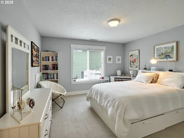 a bedroom with a large bed and a window