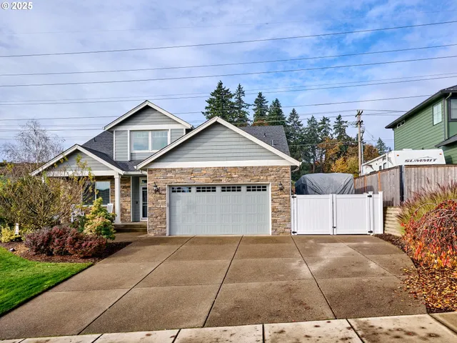 a view of a house with a yard and garage
