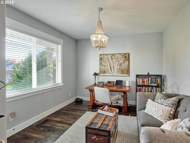 a living room with furniture piano and a window