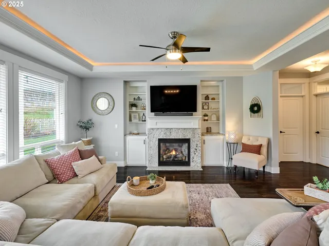 a living room with furniture a fireplace and a flat screen tv