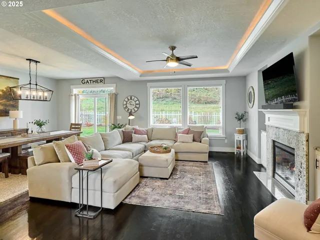 a living room with fireplace furniture and a flat screen tv