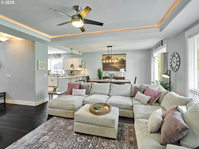 a living room with furniture and a chandelier