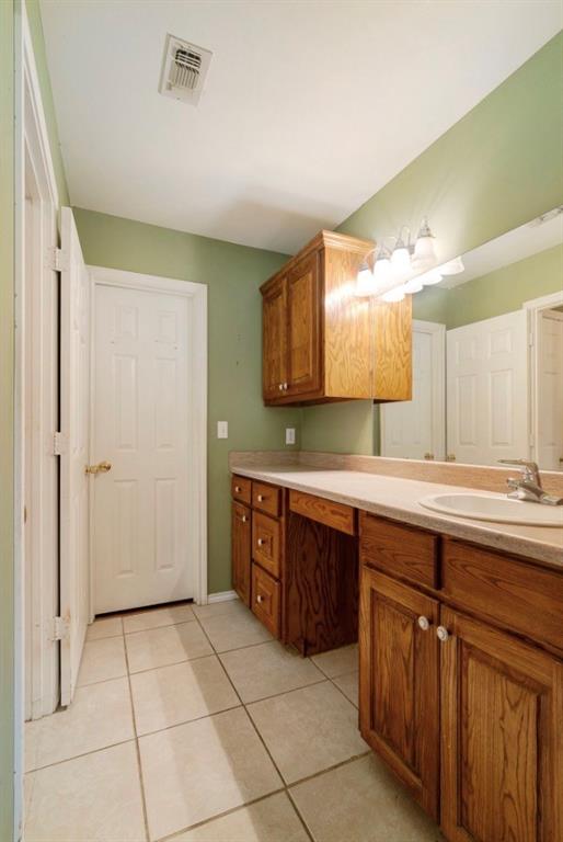 3754 County Road Paris, TX 75462 - Photo 15 of 33 a spacious bathroom with a granite countertop sink a mirror and a bathtub